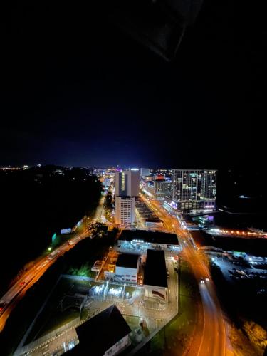 a city at night with traffic on a freeway at MiStay 4-5PAX Luxury Suite Apartments in Kota Kinabalu