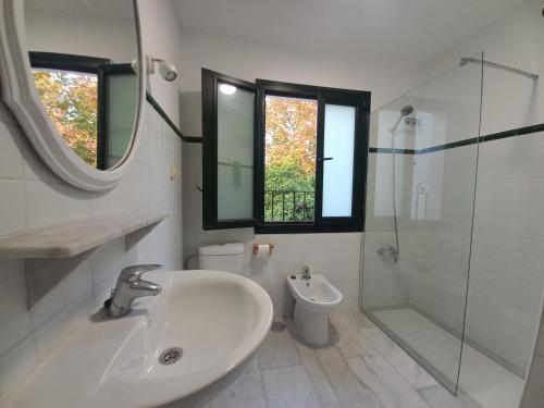 a bathroom with a sink and a shower and a toilet at Rest . . . Heliópolis in Seville