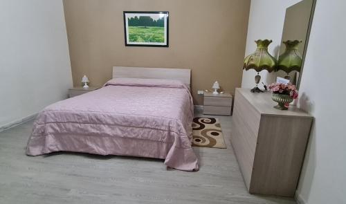 a bedroom with a bed and a dresser and a mirror at Casa Arianna in Avella