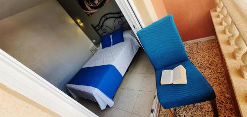 an overhead view of a bedroom with a bed and two chairs at Hostales Juan de Austria I & II in Aguadulce