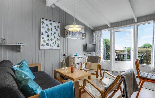 a living room with a couch and a table at Hus 30 A in Allinge