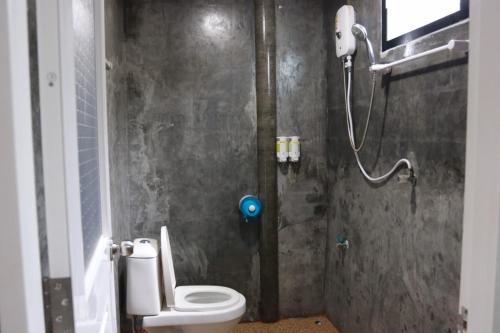 a bathroom with a shower and a toilet in it at Lanta Sabai Day House in Ko Lanta