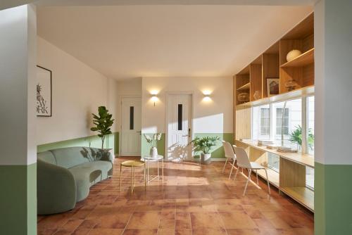 a living room with a couch and a table and chairs at M Village Cao Thắng 2 in Ho Chi Minh City