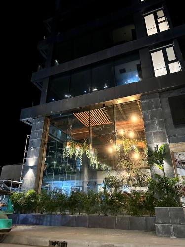 a building at night with lights in it at H Hotel El Nido - Vegan Friendly Hotel Managed by H Hospitality Group in El Nido