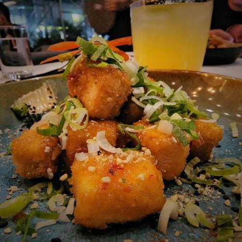 a pile of food on a plate with a drink at H Hotel El Nido - Vegan Friendly Hotel Managed by H Hospitality Group in El Nido