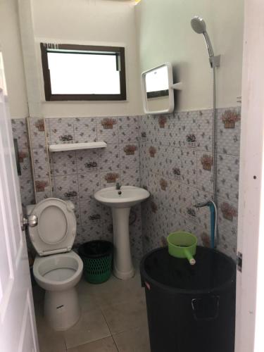 a small bathroom with a toilet and a sink at Khaosok Eco Raft in Ban Kraison