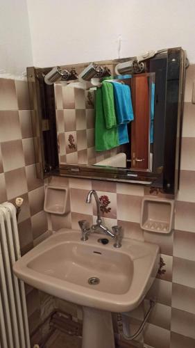 a bathroom with a sink and a mirror at Panourgia's House in Tríkala