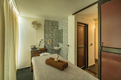 a hotel room with a bed with a towel on it at Moustache Rishikesh Luxuria in Rishīkesh