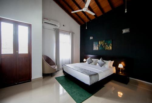 a bedroom with a large bed and a large window at The Breeze Residence, Kottawa in Kottawa