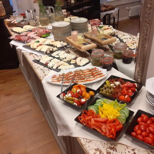 a buffet with many different types of food on a table at Wellnesshotel Waldquartier GmbH in Bad Essen
