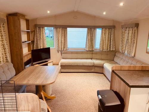 a living room with a couch and a tv at 69 Newquay bay resort Pet friendly in Newquay