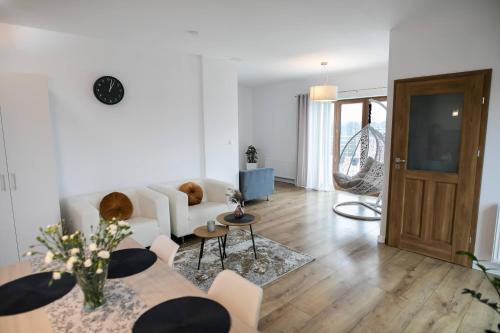 a living room with a white couch and a table at Rezydencja Margonin in Margonin