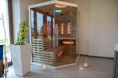 a glass cabinet with a fireplace in a room at Rezydencja Margonin in Margonin