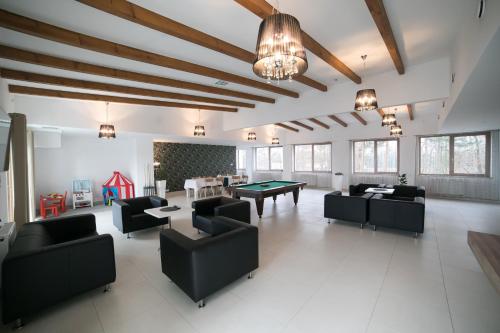 a large living room with couches and a ping pong table at Rezydencja Margonin in Margonin