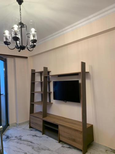 a living room with a flat screen tv on a wall at City Central Apartment in Yerevan