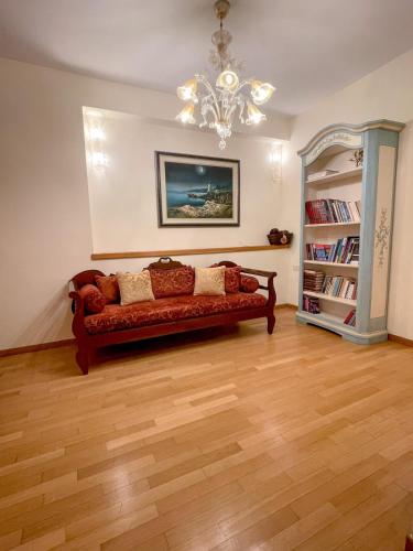 a living room with a couch and a chandelier at Villa Voulgari in Ioannina