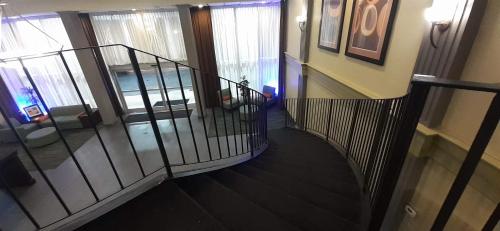 a hallway with a spiral staircase in a house at Americas Best Value Inn Phenix City in Phenix City