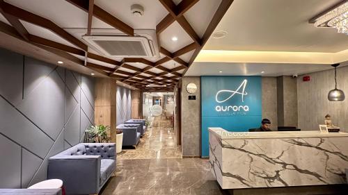 a lobby of an office with chairs and a counter at Aurora Boutique Hotel Imphal in Imphal