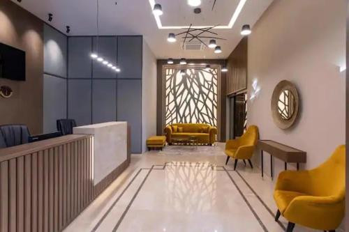 a lobby with a waiting area with yellow chairs at City Park INN - Art Studio in Plovdiv