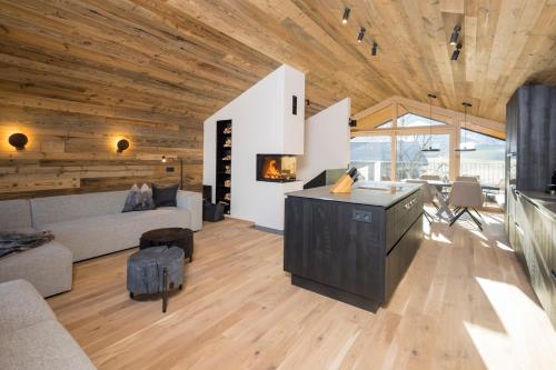 a living room with a couch and a table at Haus Sonnblick Chalet in Reith im Alpbachtal