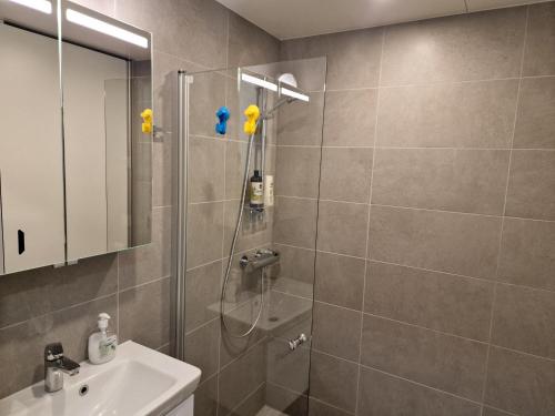 a bathroom with a shower and a sink at New Center Sity Home in Kuopio