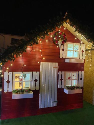 a model of a house with christmas lights on it at HOTEL CARPAT INN in Azuga