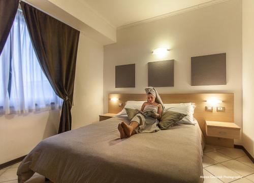 Postel nebo postele na pokoji v ubytování Hotel Bussana