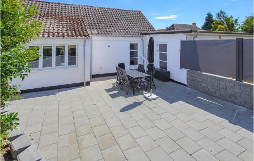 a patio with a bench and a house at Lovely Apartment In Samsø With Wifi in Onsbjerg