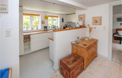 a kitchen with white cabinets and a counter top at Lovely Apartment In Samsø With Wifi in Onsbjerg