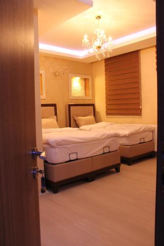 Ένα ή περισσότερα κρεβάτια σε δωμάτιο στο Kars Konak Hotel