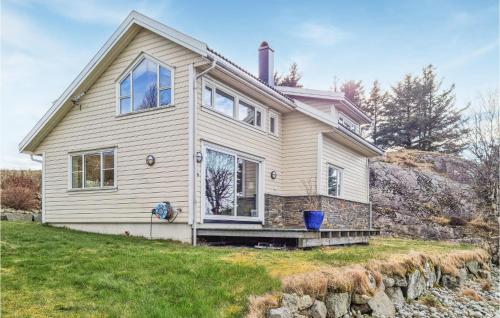 a house on a hill with a stone wall at Cozy Home In Egersund With Wifi in Egersund