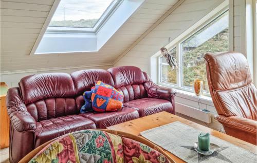 a living room with a leather couch and a table at Cozy Home In Egersund With Wifi in Egersund
