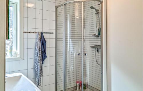 a shower with a glass door in a bathroom at Nice Home In Egersund With Wifi in Egersund