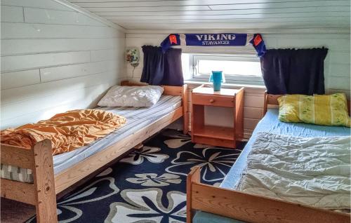 a room with two bunk beds and a window at Nice Home In Egersund With Wifi in Egersund