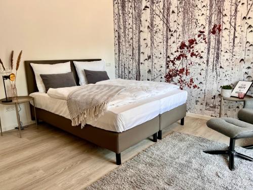 a bedroom with a bed and a chair at SOFI-LIVING-APARTMENTS in Hannover
