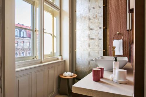 a bathroom with a sink and a window at Andaz Prague, By Hyatt in Prague