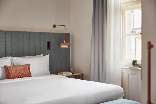 a bedroom with a white bed and a window at Andaz Prague, By Hyatt in Prague