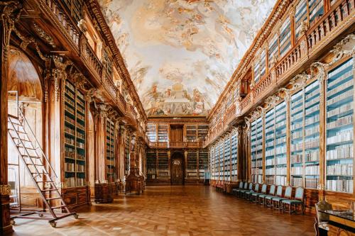 a large library with a painting on the ceilings at Andaz Prague, By Hyatt in Prague