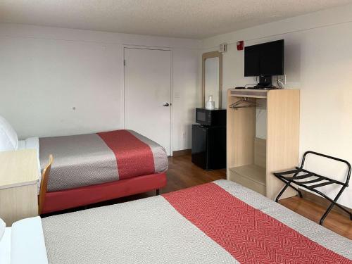 a hotel room with two beds and a television at Motel 6 Hagerstown MD in Hagerstown