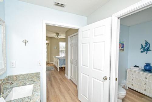 a white bathroom with a sink and a toilet at Seaside At Anastasia 202 Condo in Saint Augustine