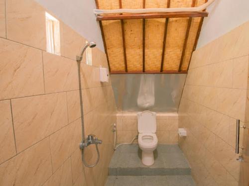 a bathroom with a toilet and a shower at Sun Colada Villas & Spa in Nusa Penida