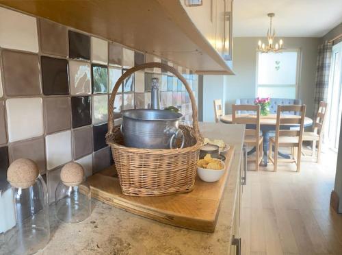 a kitchen with a table with a basket on a counter at The Annex: 2 bedroom cottage, countryside, peaceful getaway with garden in Easingwold