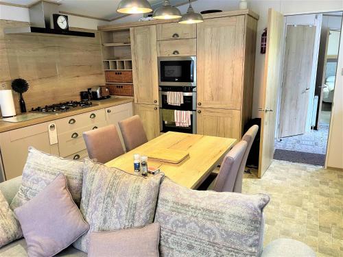 a kitchen with a table and a couch in a kitchen at Rockley Park Private Holiday Homes in Poole