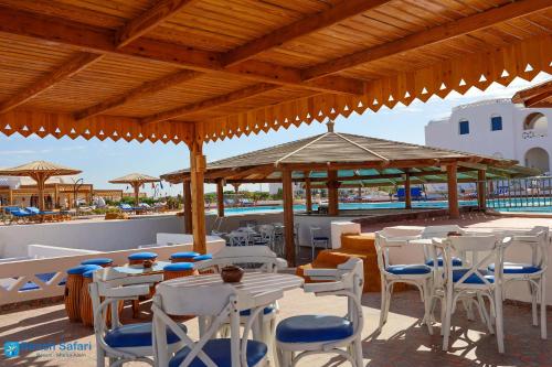a group of tables and chairs under a pavilion at Beach safari nubian resort in Marsa Alam City