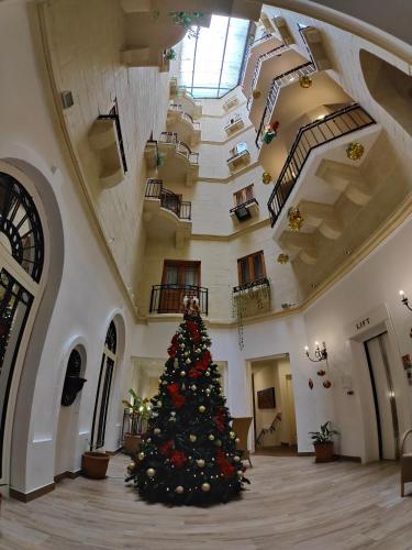 a christmas tree in the middle of a building at St. Patrick's Hotel in Xlendi