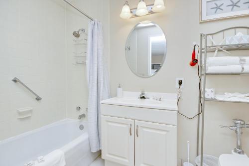 uma casa de banho branca com um lavatório e um espelho em The Condo on Ocean Blvd em Myrtle Beach