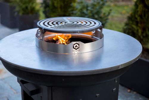 a fire pit on a table with a fire oven at Haus Sonnblick Chalet in Reith im Alpbachtal