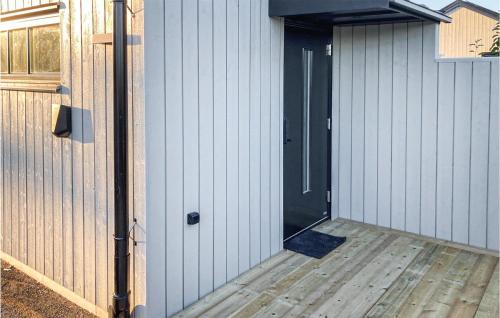 una puerta a un edificio con terraza de madera en Nice Home In Varberg With Wifi, en Varberg