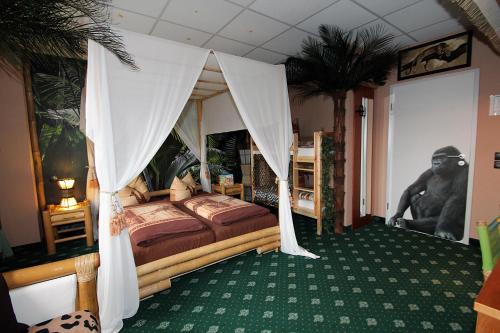 a bedroom with a bed with a canopy at Hotel Berlin in Leipzig