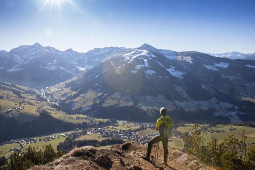 a man standing on top of a mountain overlooking a valley at Haus Sonnblick Chalet in Reith im Alpbachtal
